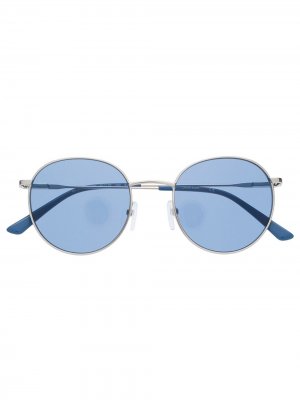 Солнцезащитные очки в круглой оправе Calvin Klein. Цвет: золотистый