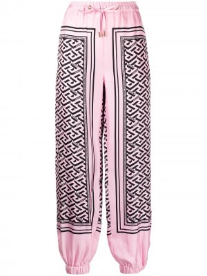 Зауженные шелковые брюки с монограммой Versace. Цвет: розовый